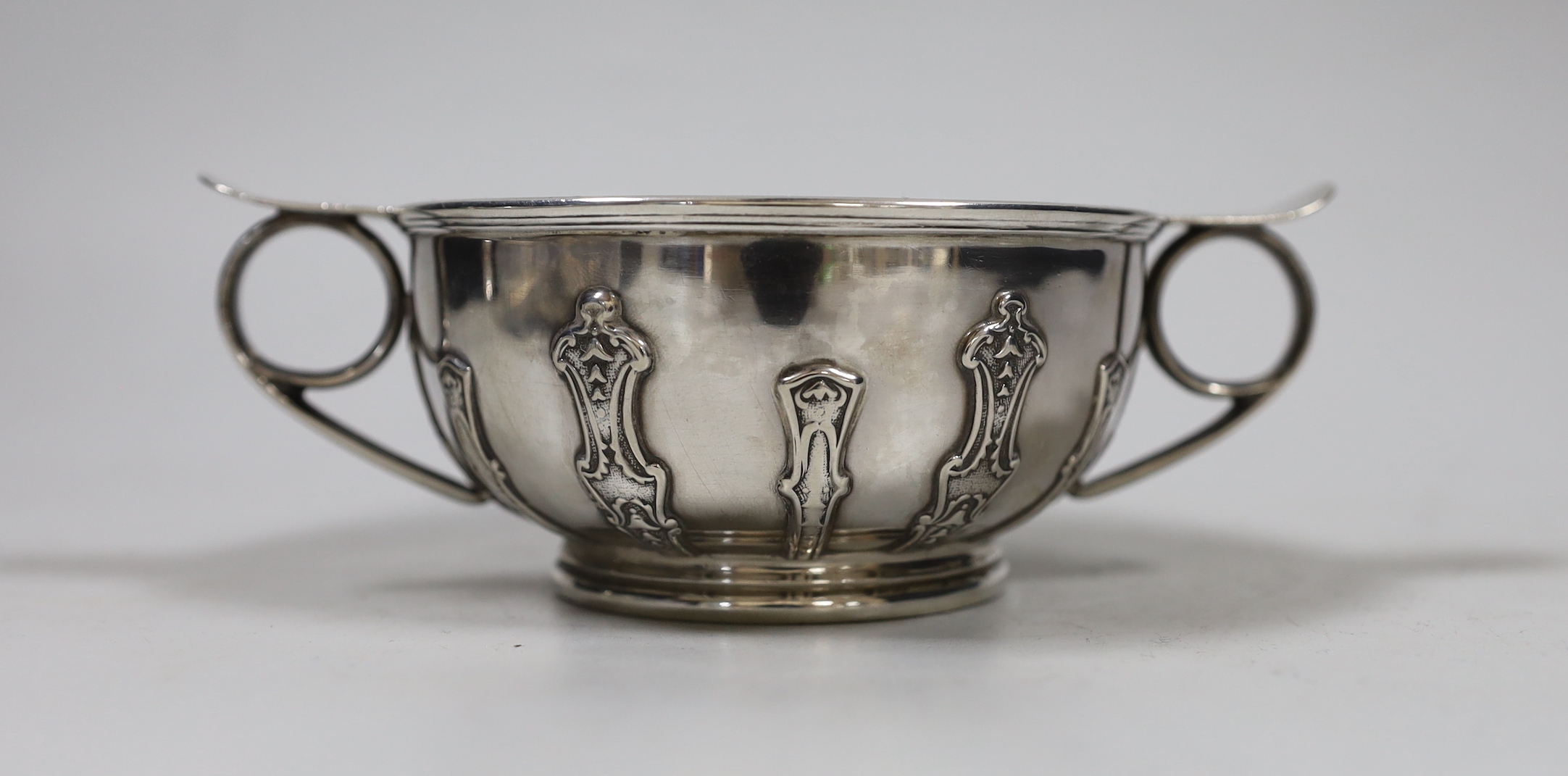 A George V silver two handled bowl, with cut card decoration, Goldsmiths & Silversmiths Co Ltd London, 1926. diameter 16.3cm over handles, 8.4oz.